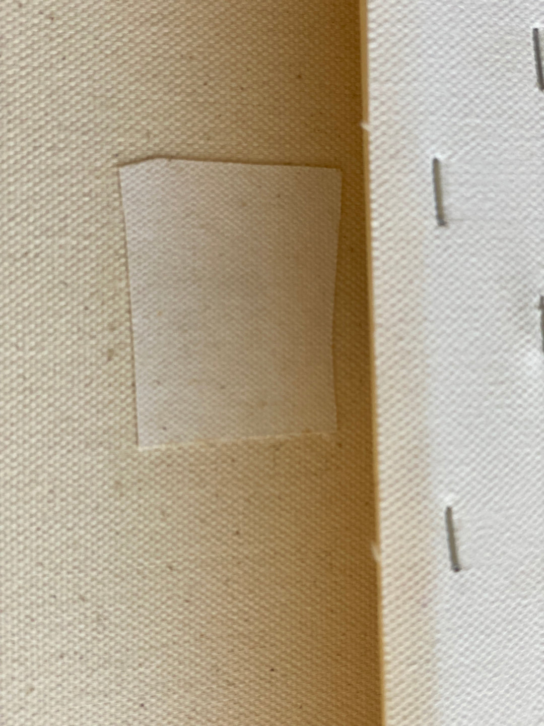 Repair patch on back of canvas 